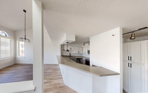 A kitchen with white cabinets and a countertop.