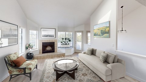 A living room with a fireplace and a painting on the wall.