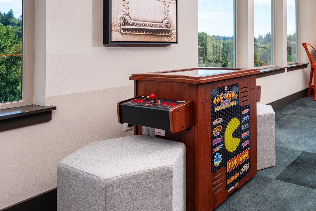 an old arcade game in a room with a chair