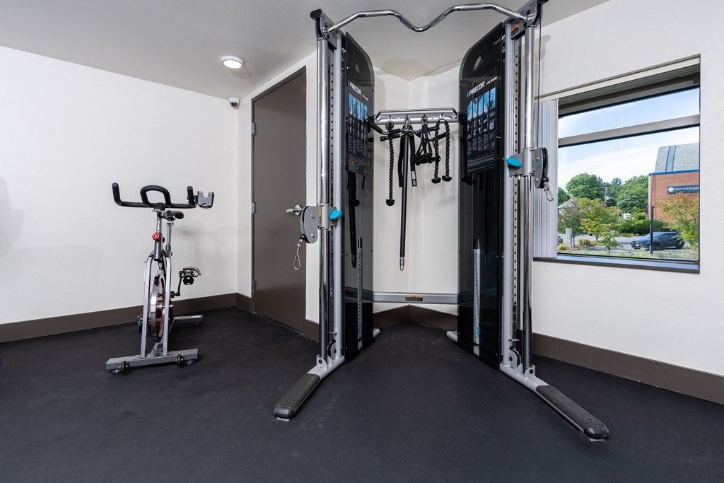 a fitness room with exercise equipment and a bike in it