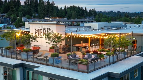 The MEDC building is lit up with string lights at dusk.