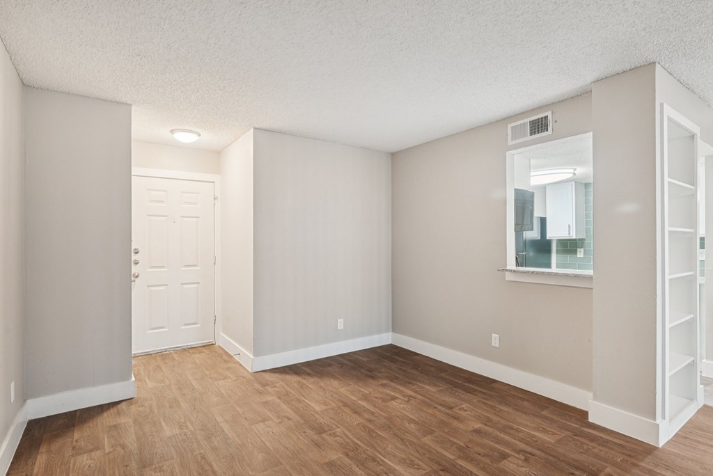 A room with a white door and a window with a white frame.