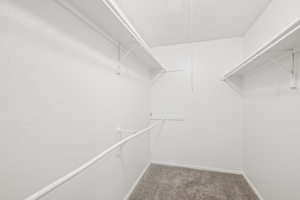 A white room with a carpeted floor and white walls.
