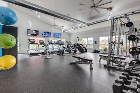 Fitness center with cardio and strength training equipment at The Northern at Coeur dAlene Place Apartments, Coeur dAlene, ID