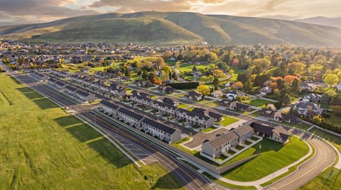 A suburban area with a road running through it and houses on both sides.