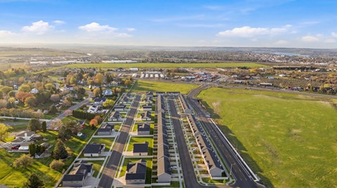 A large aerial view of a suburban area with a complex of buildings and a road network.