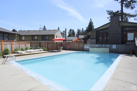 Large blue community swimming pool at The Rosewood Apartments in Vancouver, Washington.