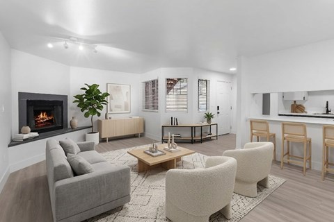 A modern living room with a grey sofa, a wooden coffee table, and a fireplace.