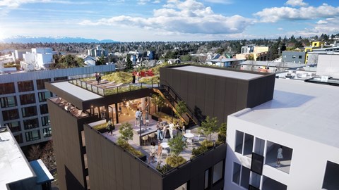A modern building with a rooftop garden is surrounded by other buildings.