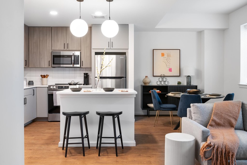 A modern kitchen with a bar area and a dining table set up.