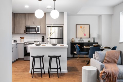 A modern kitchen with a bar area and a dining table set up.