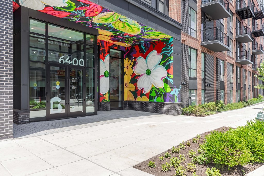 A colorful mural of flowers is painted on the front of a building.
