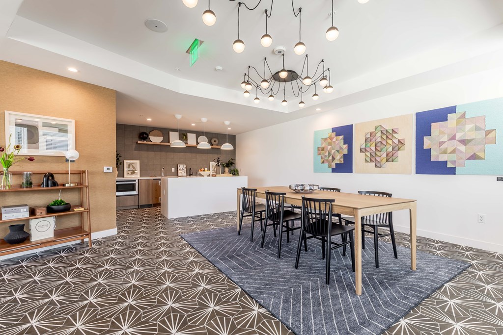 A dining room with a table set for four.
