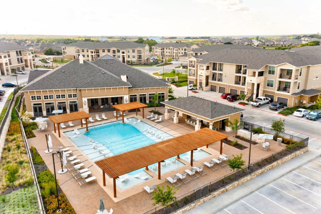 The Southbrook Apartments in Leander, Texas Exterior and Pool with Lounge Chairs