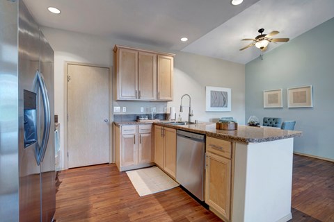 A modern kitchen with wooden cabinets and stainless steel appliances.