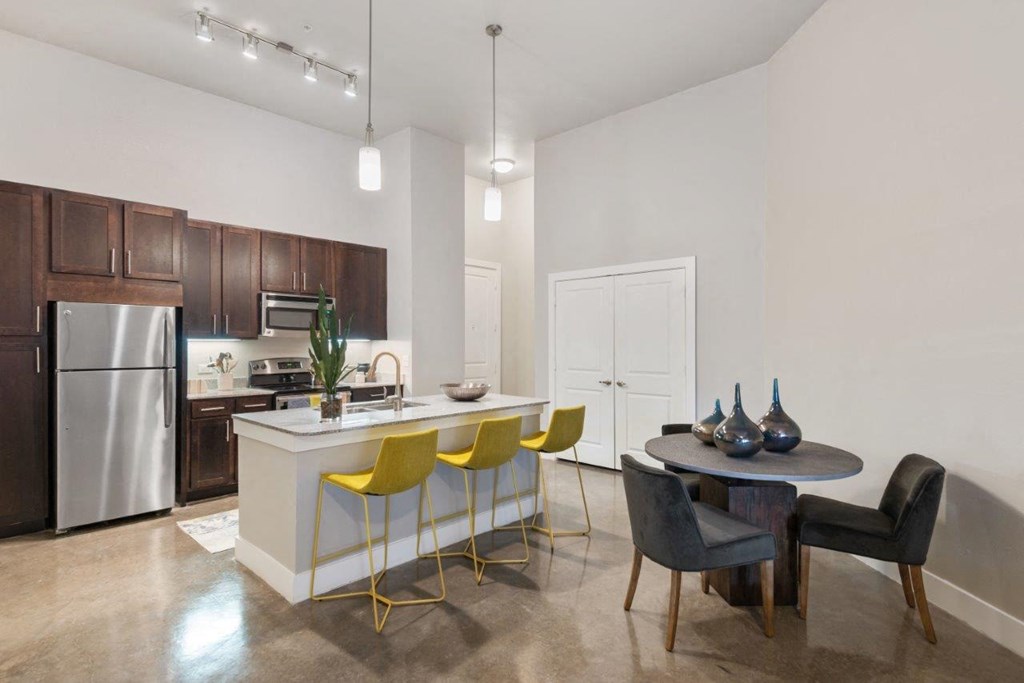 The Wall Street Lofts in Midland, Texas Model Kitchen with Island and Dining Area