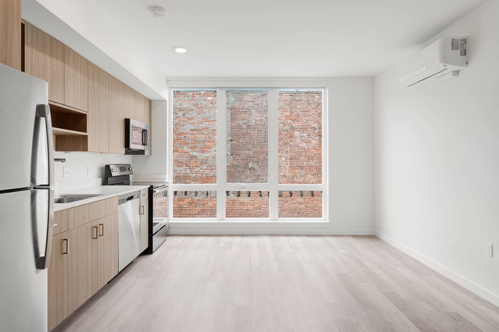 The Warren Apartments kitchen and stainless steel appliances and living room