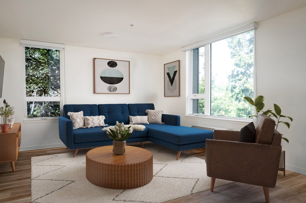 The Wes Gresham Oregon Apartments A living room with a blue couch and a brown armchair.