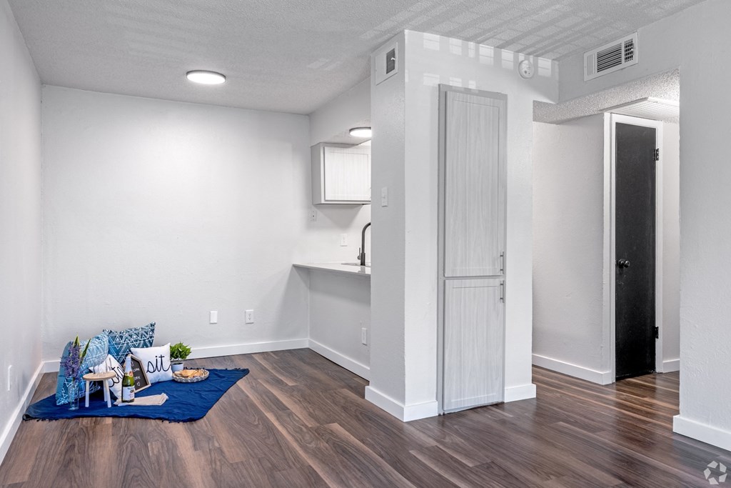 the living room and kitchen in a renovated apartment