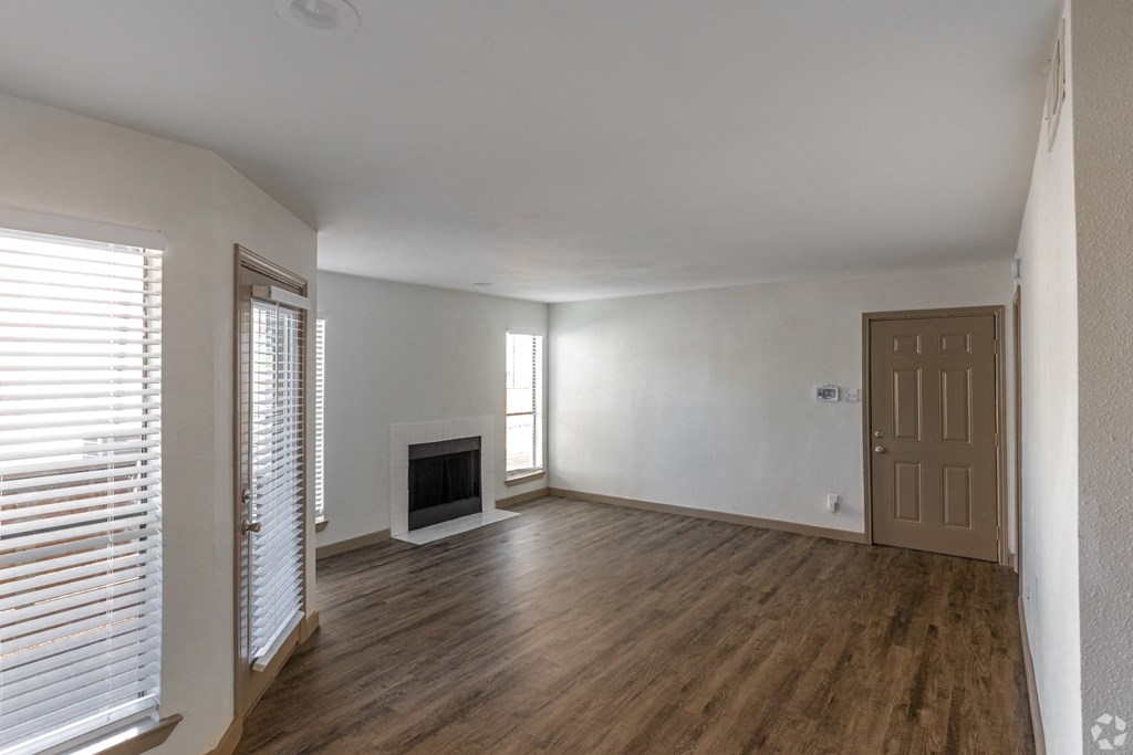 The Beckham Apartments living room with wood flooring and a fireplace