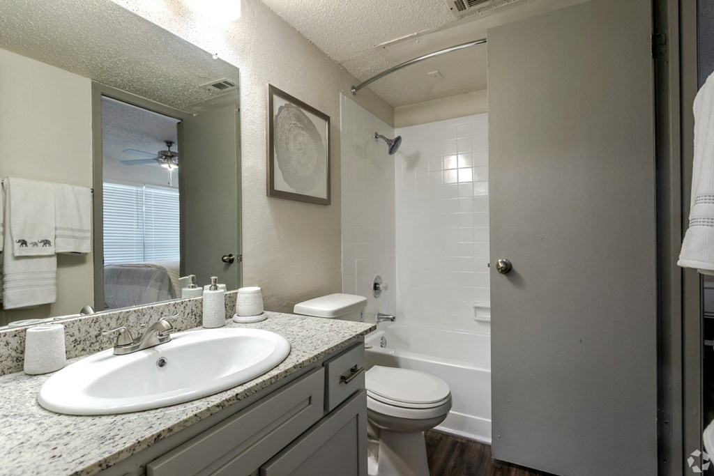 The Bentley Apartment Homes bathroom with sink toilet and shower