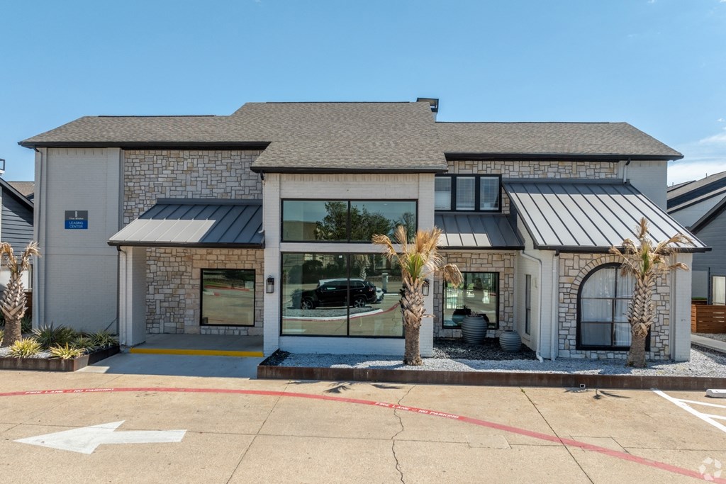the exterior of a building with palm trees in front of it