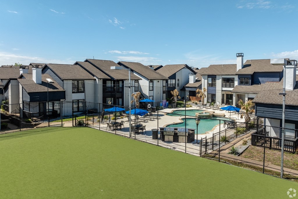 a view of a swimming pool with apartments in the background