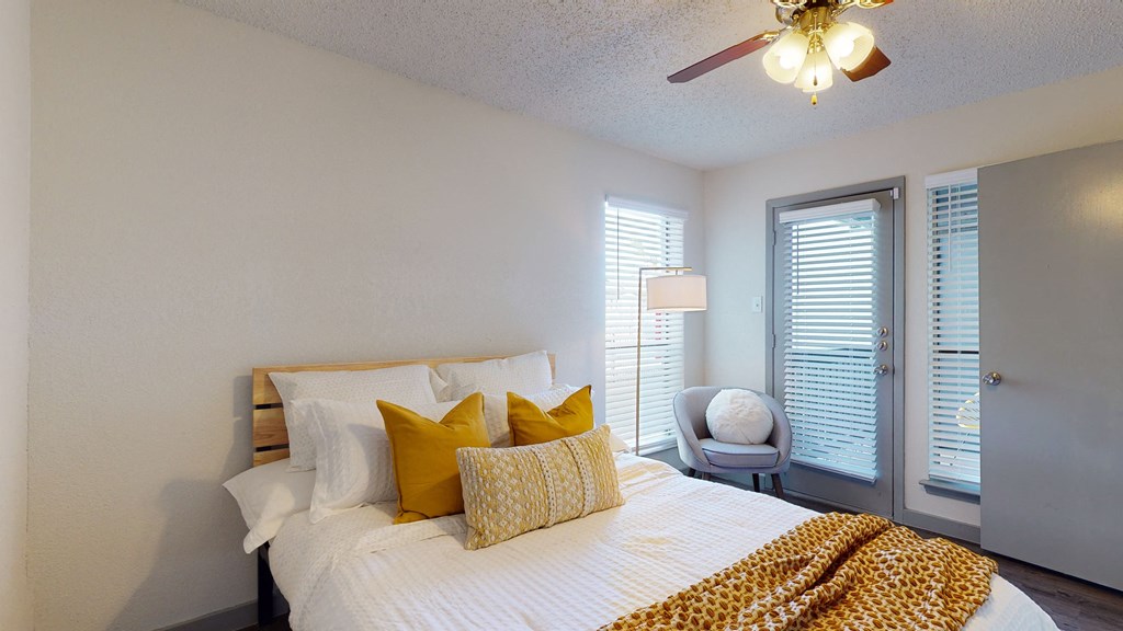 a bedroom with a large bed and a ceiling fan