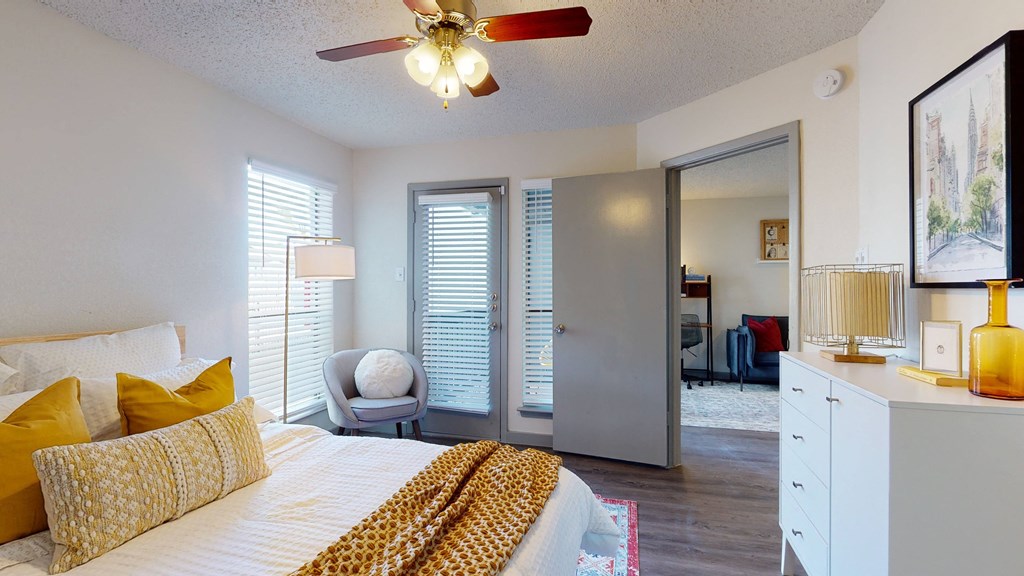 a bedroom with a large bed and a ceiling fan