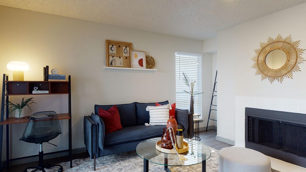 a living room with a couch and a table and a fireplace