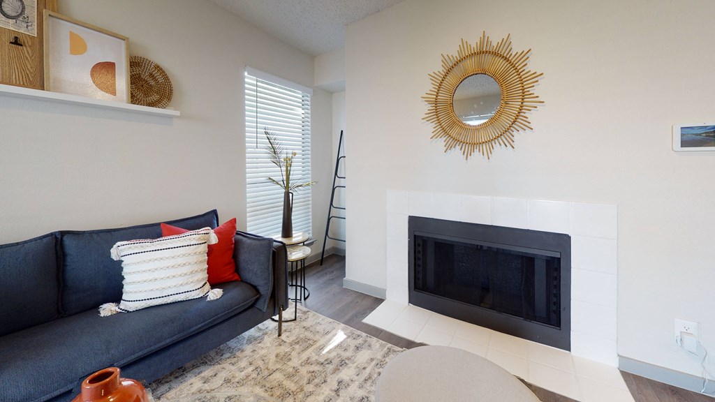 a living room with a fireplace and a blue couch