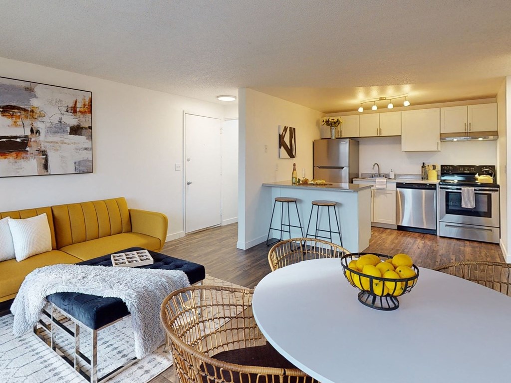 a living room with a white table and a kitchen