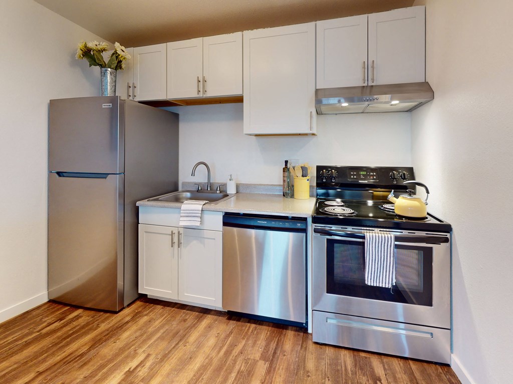 a kitchen with stainless steel appliances and a refrigerator