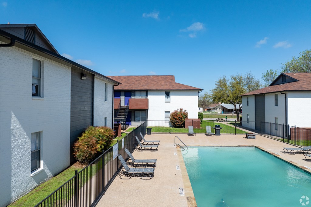 our apartments have a swimming pool and a patio with lounge chairs