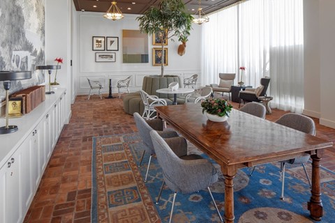 A dining room with a wooden table surrounded by chairs.