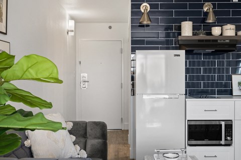 a kitchen with a refrigerator and a microwave