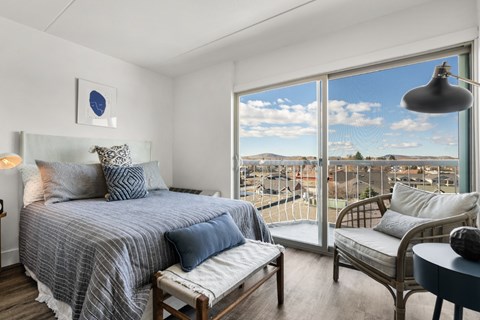 Bedroom with balcony and scenic mountain views at The Franklin Apartments, Richland