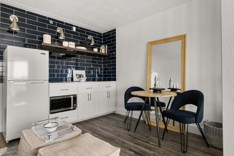 Contemporary kitchenette with black subway tile backsplash at The Franklin Apartments, Washington