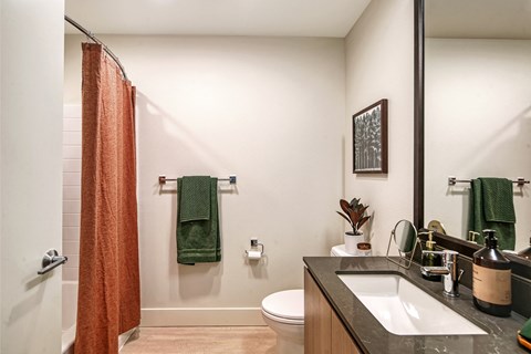 a bathroom with a toilet sink and shower