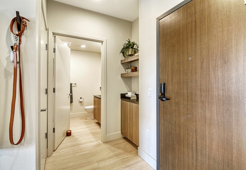 a hallway with wooden floors and a wooden door