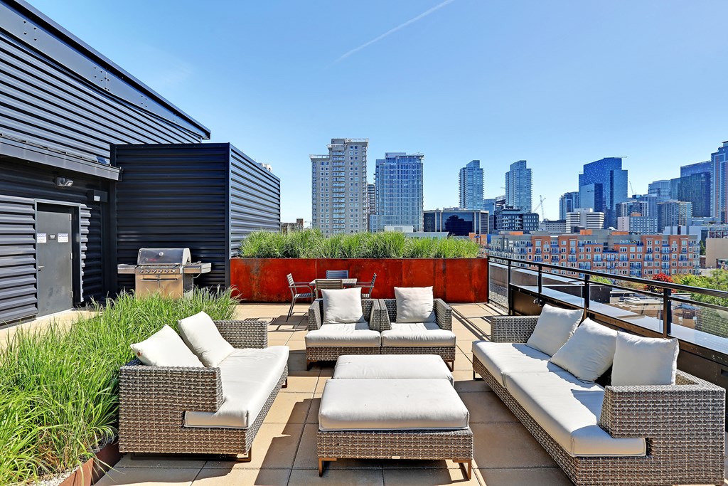 a rooftop deck with a city skyline in the background