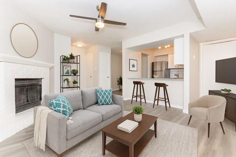 A living room with a grey couch and a coffee table.