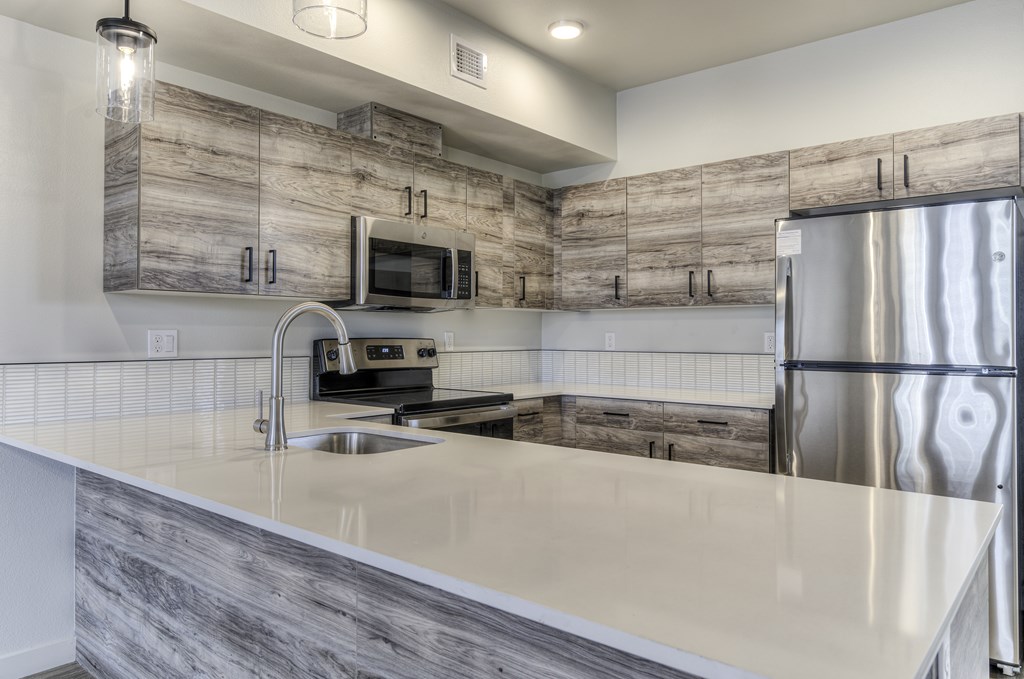 A modern kitchen with a wooden backsplash and stainless steel appliances.