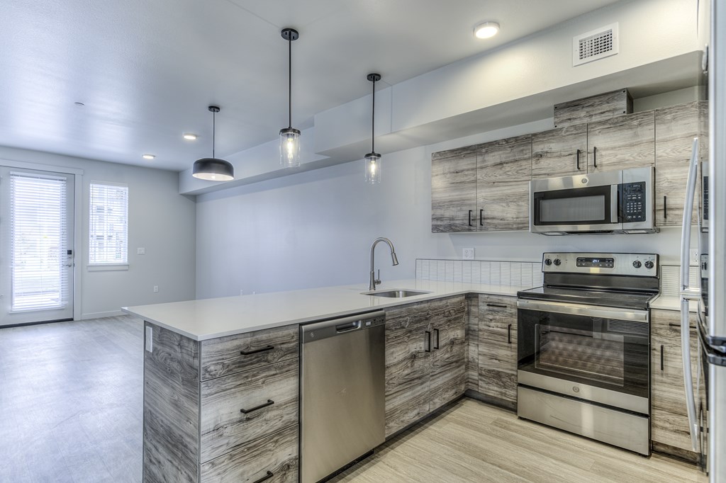 A modern kitchen with wooden cabinets and stainless steel appliances.