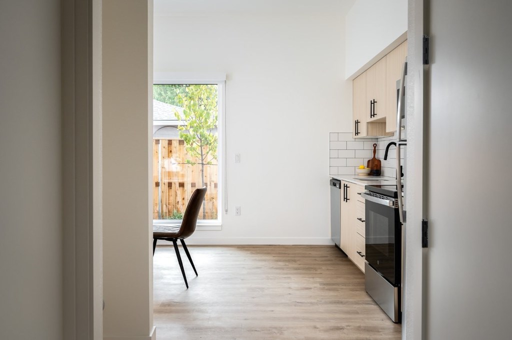 The Wes Gresham Oregon Apartments view of kitchen with a chair and a window.