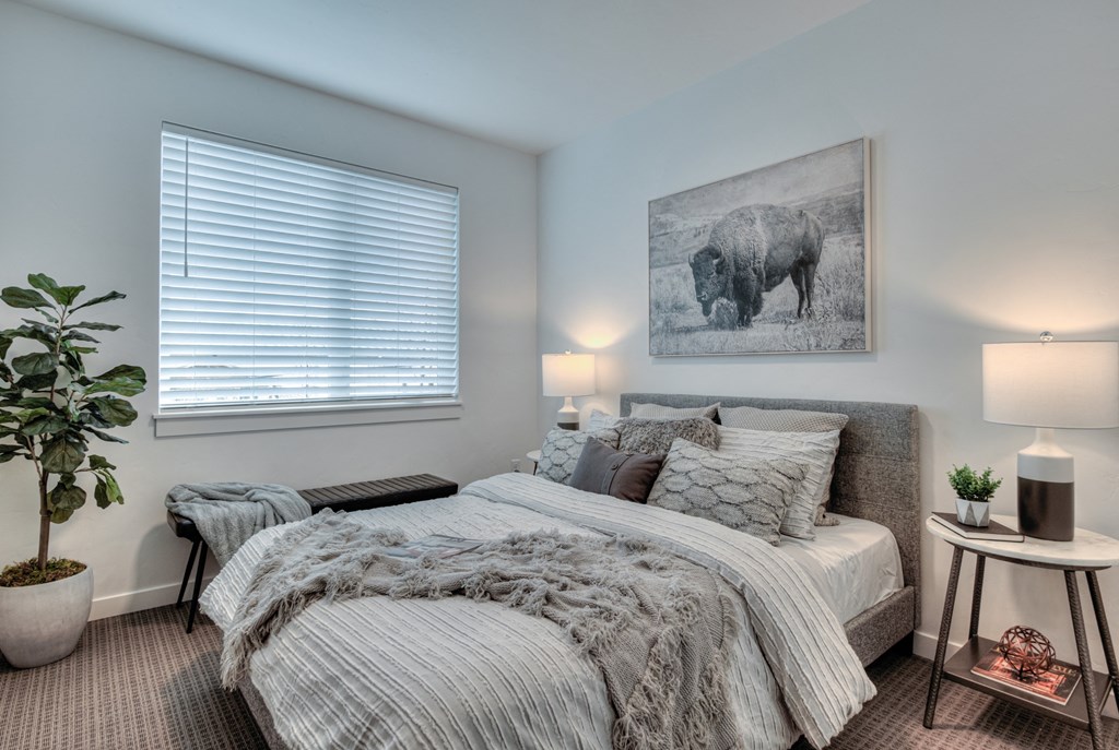 a bedroom with a bed and a painting of a cow