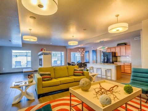 a living room with a yellow couch and a table