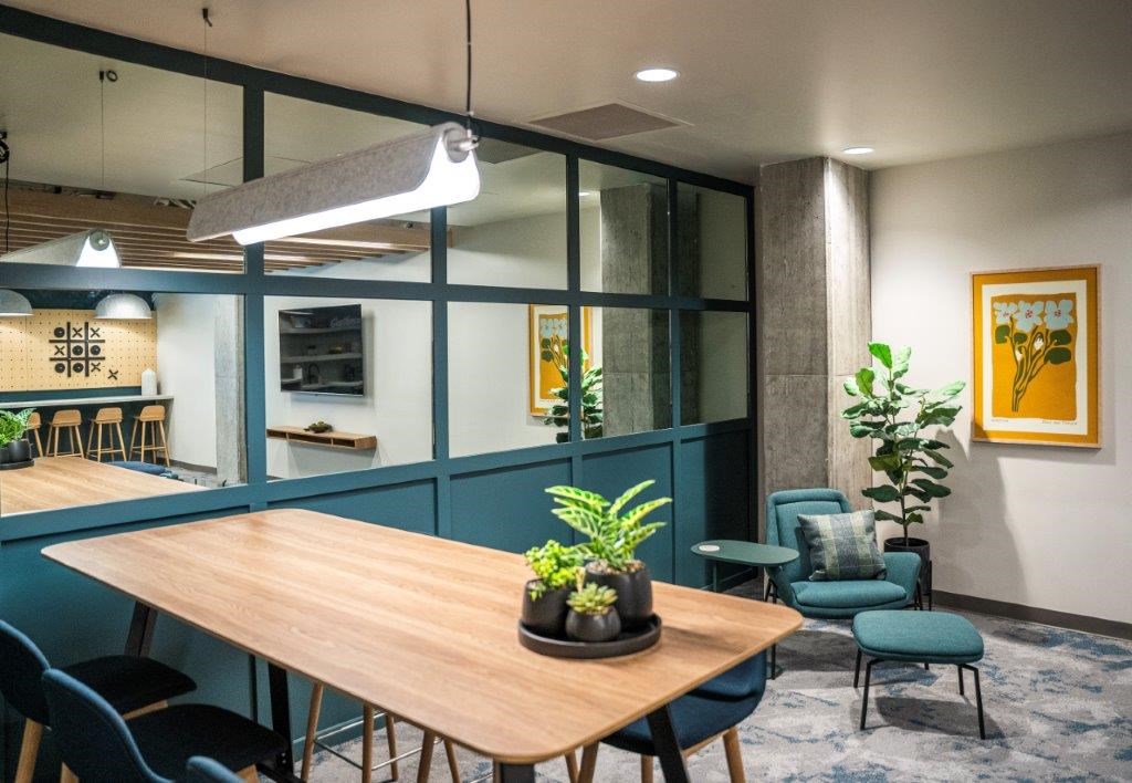 a dining room with blue chairs and a wooden table