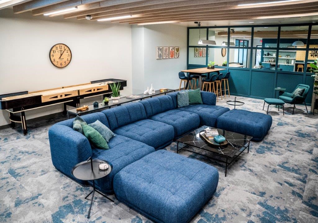 a living room with a blue couch and a table