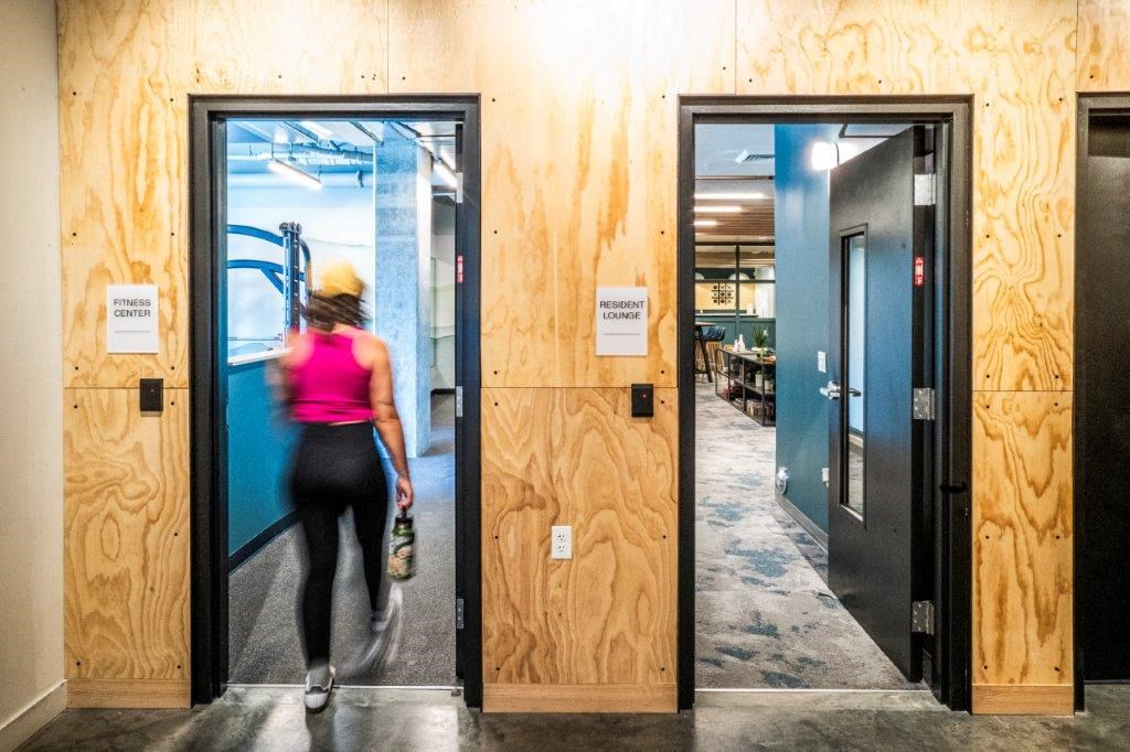 a woman running through a door in a building